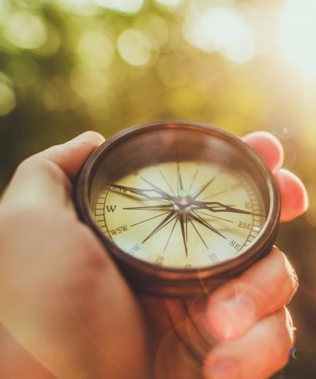 Person holding a compass